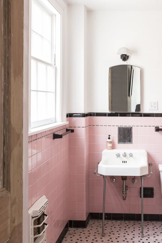 white bathroom with pink and black tiles