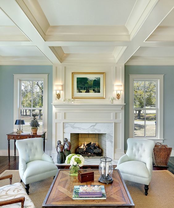 timeless white fireplace with blue walls