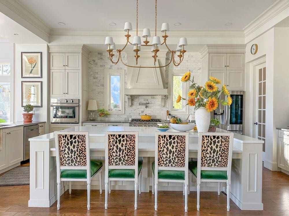 warm neutral kitchen gold island chandelier marble backsplash