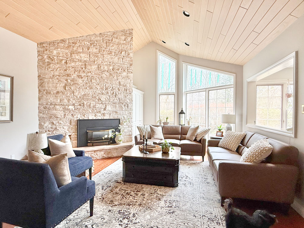 living room with stone fireplace